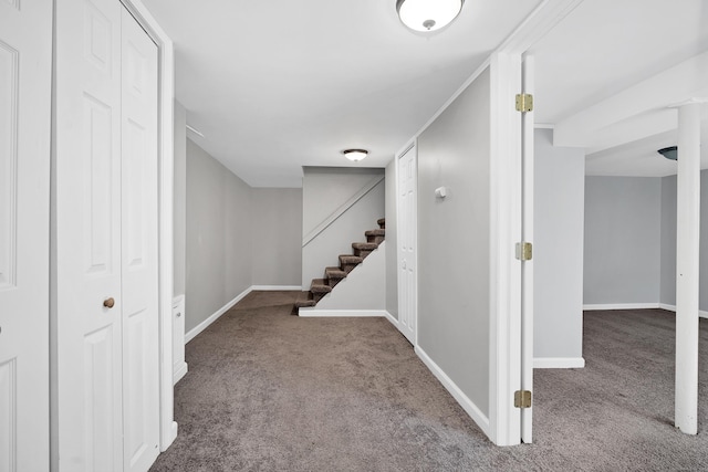 finished below grade area with stairs, baseboards, and carpet floors