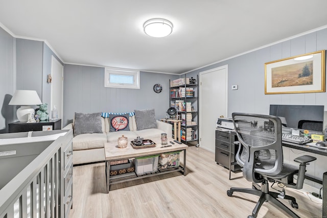 office area featuring light wood-style flooring and crown molding