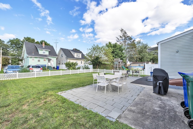 view of yard featuring a playground, outdoor dining area, a patio area, and a fenced backyard