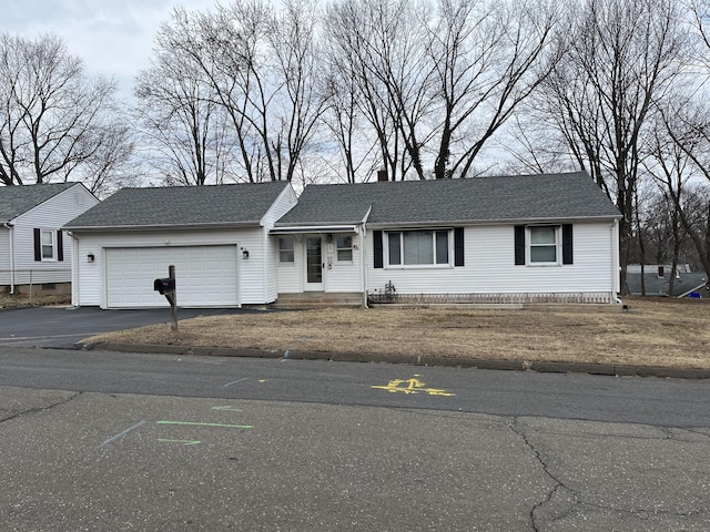 single story home featuring a garage, roof with shingles, a chimney, and aphalt driveway