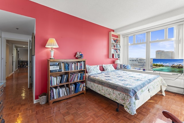 bedroom featuring a textured ceiling and baseboards