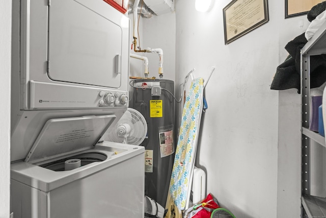 laundry area featuring stacked washing maching and dryer, water heater, and laundry area