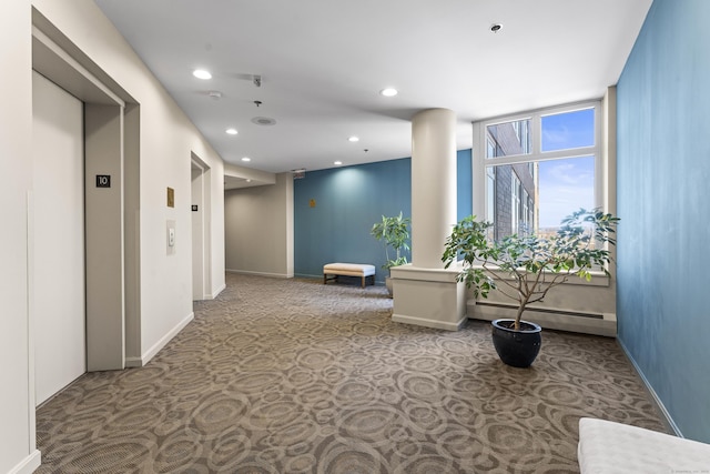 corridor with carpet, recessed lighting, baseboard heating, elevator, and baseboards