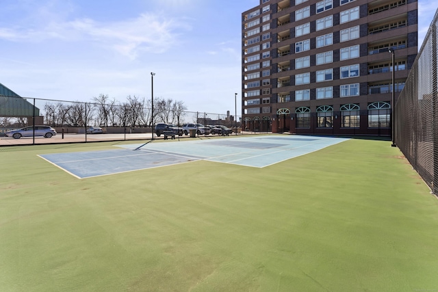 view of sport court with fence