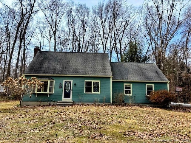 cape cod-style house featuring a chimney