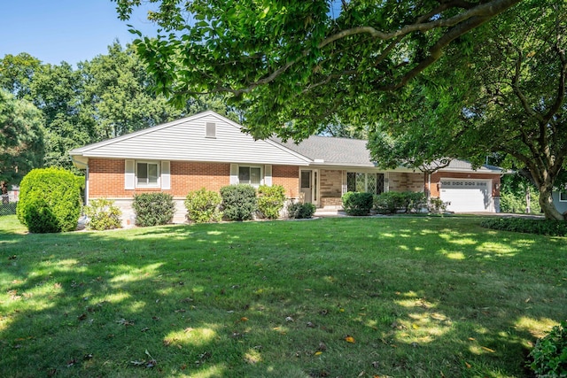 ranch-style house featuring a garage, brick siding, and a front lawn