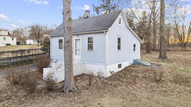 view of outbuilding with fence