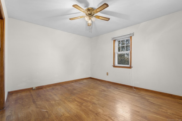 spare room with ceiling fan, baseboards, and wood finished floors