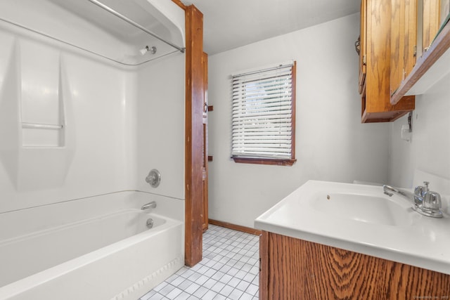 bathroom with baseboards, shower / bathing tub combination, vanity, and tile patterned floors