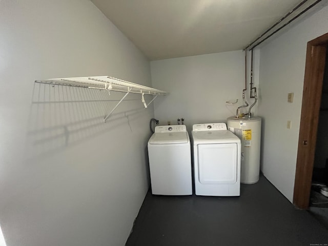 laundry area featuring laundry area, washing machine and clothes dryer, and electric water heater