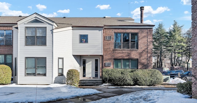 townhome / multi-family property with brick siding