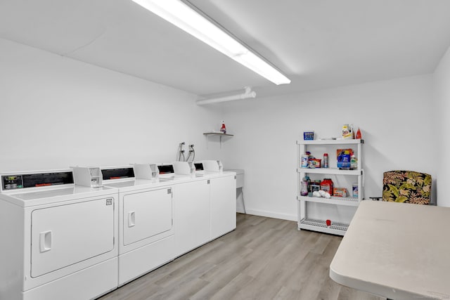 common laundry area featuring light wood-type flooring and washer and clothes dryer