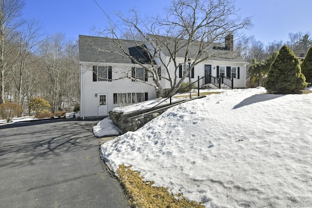 view of front facade featuring a chimney