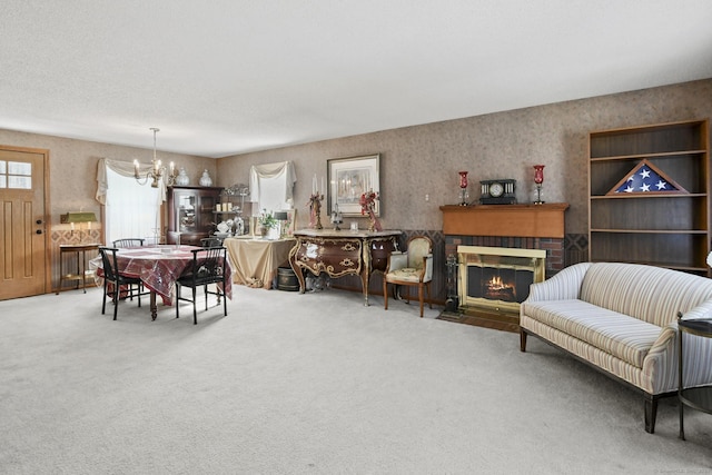 dining room with carpet floors, wallpapered walls, a fireplace, and an inviting chandelier