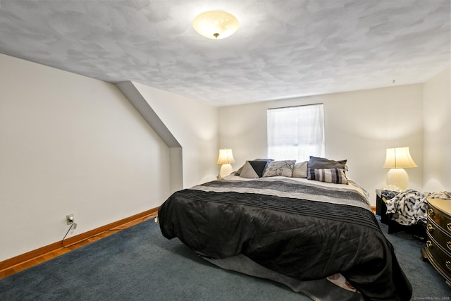 bedroom featuring baseboards and wood finished floors