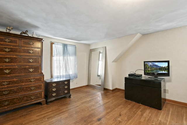 office space featuring baseboards and wood finished floors