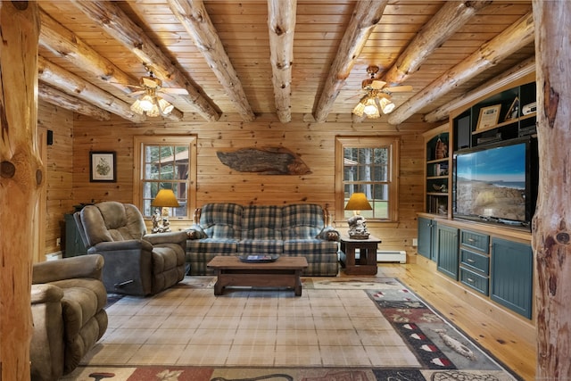 living room featuring ceiling fan, beamed ceiling, hardwood / wood-style flooring, and a healthy amount of sunlight