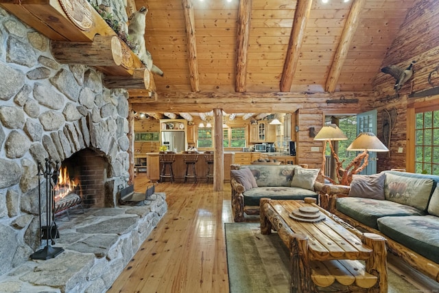 living area featuring a stone fireplace, wooden ceiling, beam ceiling, light wood finished floors, and rustic walls