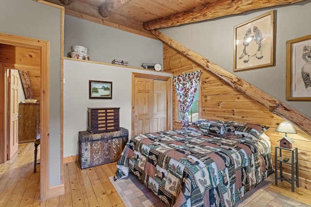 bedroom featuring wooden ceiling, vaulted ceiling with beams, wooden walls, and hardwood / wood-style flooring