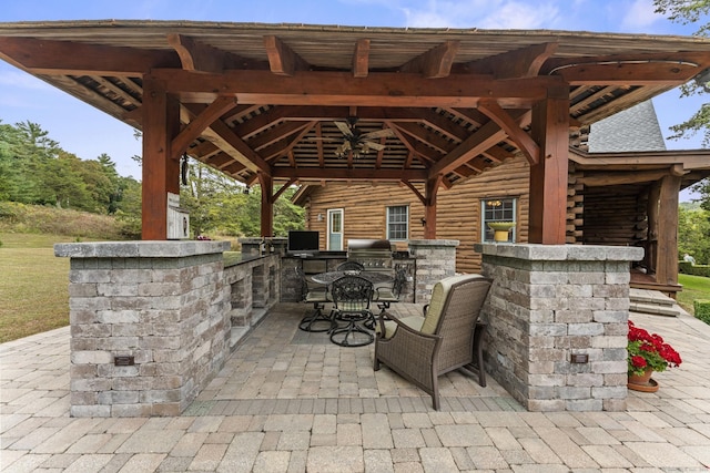 view of patio / terrace with exterior kitchen, grilling area, and a gazebo