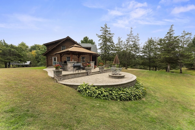 back of house featuring a patio area, a fire pit, log siding, and a lawn