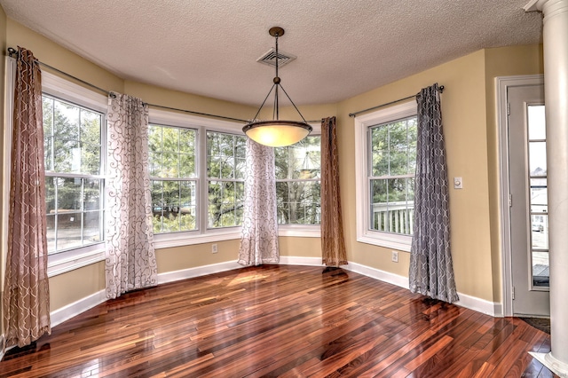 75 Redwood Dr Unit 510, East Haven, CT 06513 - unfurnished dining area with a textured ceiling, dark wood-type flooring, visible vents, and baseboards