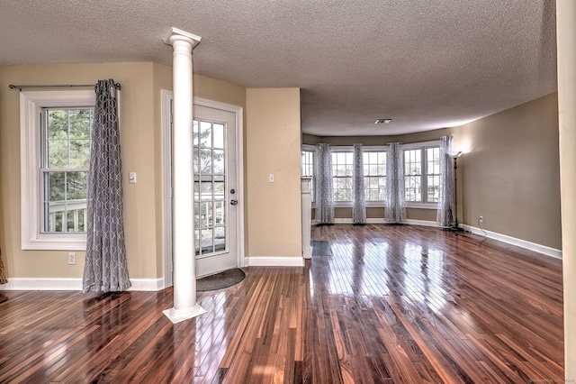 75 Redwood Dr Unit 510, East Haven, CT 06513 - interior space with baseboards, dark wood finished floors, a textured ceiling, and ornate columns