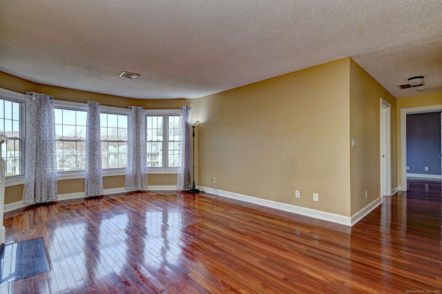 75 Redwood Dr Unit 510, East Haven, CT 06513 - empty room with baseboards, visible vents, a textured ceiling, and hardwood / wood-style floors