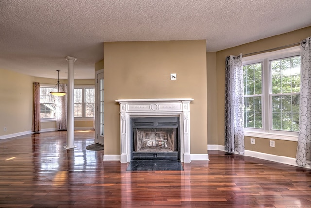 75 Redwood Dr Unit 510, East Haven, CT 06513 - unfurnished living room featuring ornate columns, a fireplace with flush hearth, baseboards, and wood finished floors