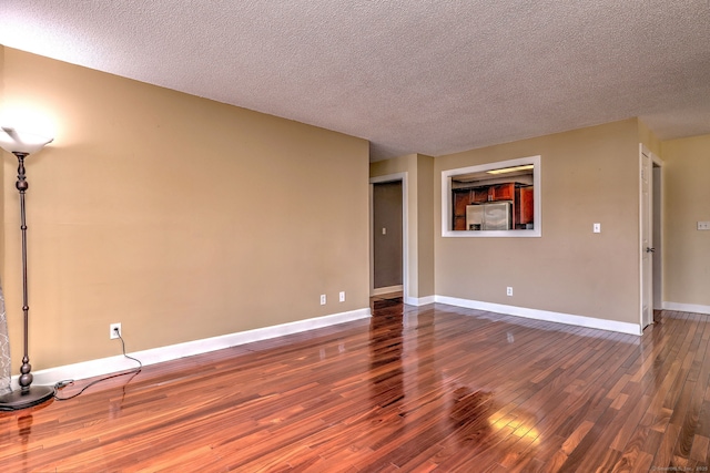 75 Redwood Dr Unit 510, East Haven, CT 06513 - unfurnished living room with a textured ceiling, baseboards, and wood finished floors
