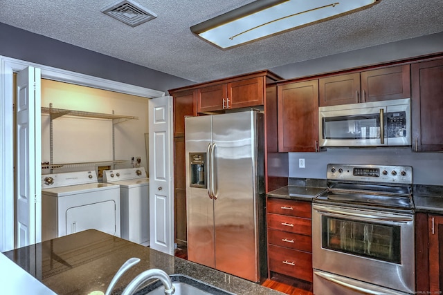 75 Redwood Dr Unit 510, East Haven, CT 06513 - kitchen featuring stainless steel appliances, washer and dryer, visible vents, and a textured ceiling
