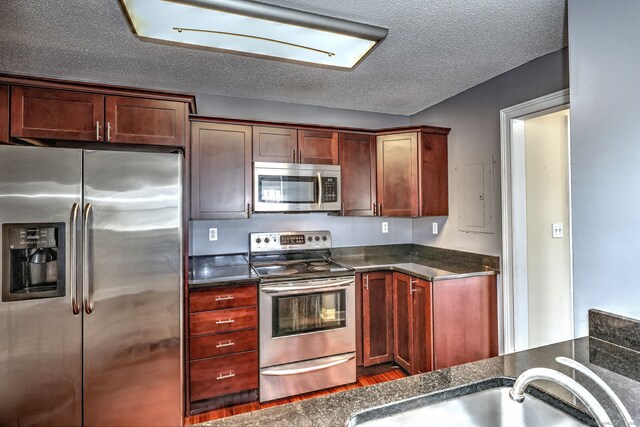 75 Redwood Dr Unit 510, East Haven, CT 06513 - kitchen with dark countertops, a textured ceiling, stainless steel appliances, and a sink