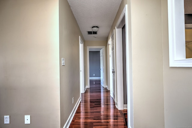75 Redwood Dr Unit 510, East Haven, CT 06513 - corridor with dark wood-type flooring, visible vents, a textured ceiling, and baseboards