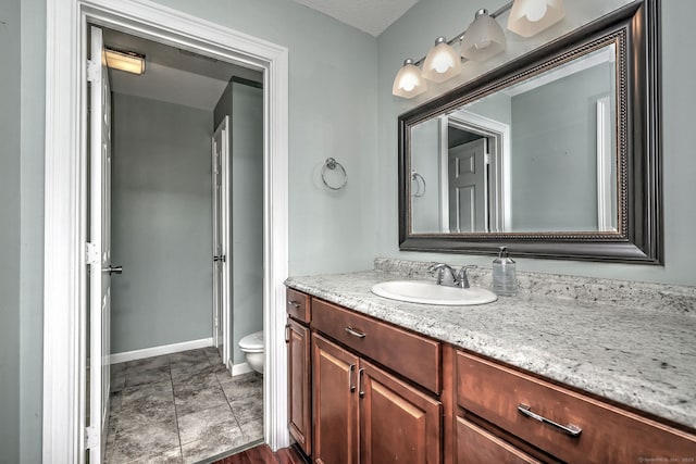 75 Redwood Dr Unit 510, East Haven, CT 06513 - bathroom featuring vanity, toilet, and baseboards