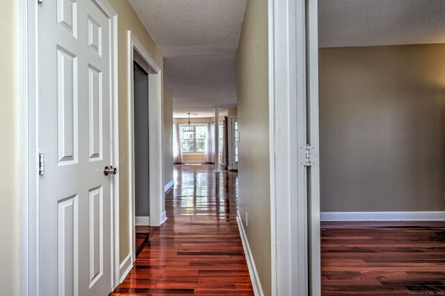 75 Redwood Dr Unit 510, East Haven, CT 06513 - hallway with dark wood finished floors, a textured ceiling, and baseboards