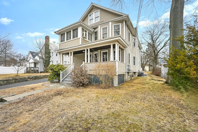 traditional style home featuring fence and covered porch