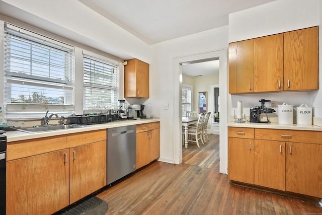 kitchen with brown cabinetry, a sink, dark wood-type flooring, light countertops, and dishwasher