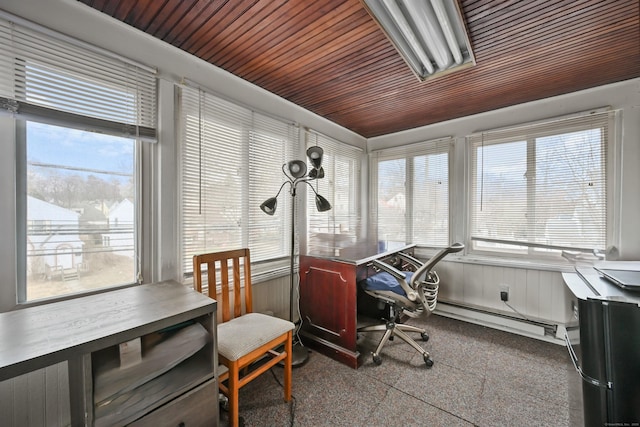 home office with a baseboard heating unit and plenty of natural light