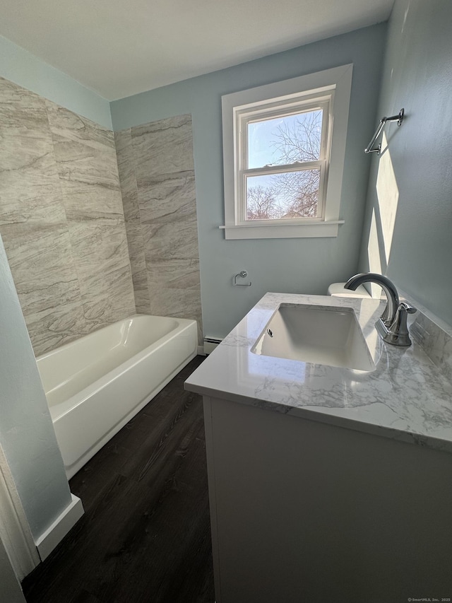 bathroom featuring vanity, wood finished floors, and a baseboard radiator