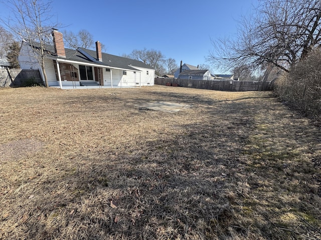 view of yard featuring a patio and a fenced backyard