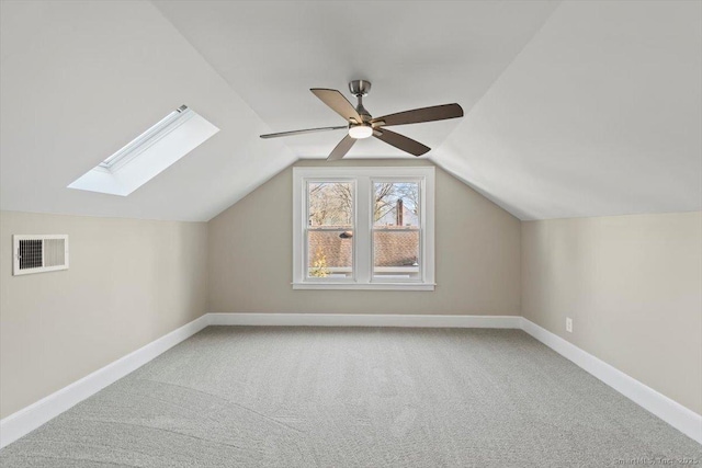 additional living space featuring carpet, visible vents, vaulted ceiling, ceiling fan, and baseboards