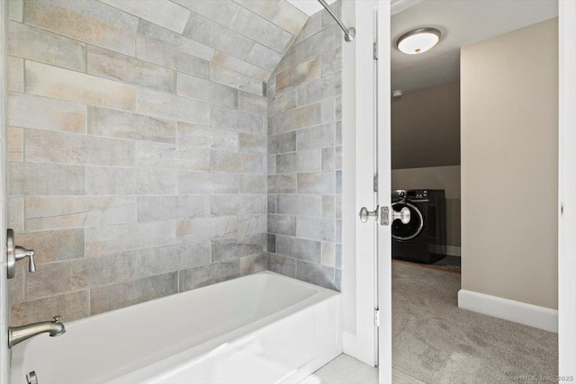 bathroom featuring baseboards, washer / clothes dryer, and shower / bathing tub combination