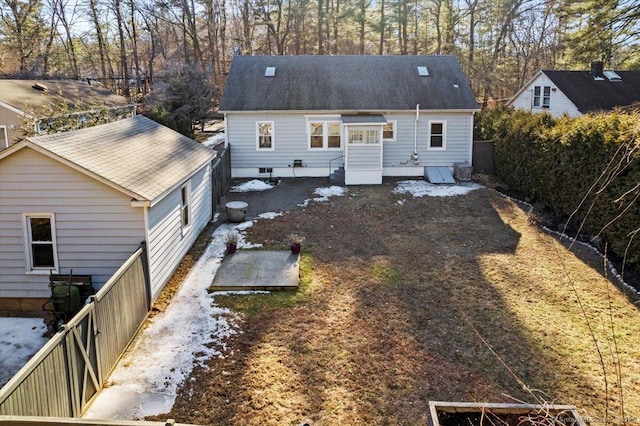 rear view of property featuring fence