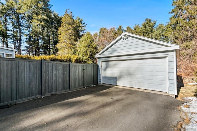 detached garage featuring fence