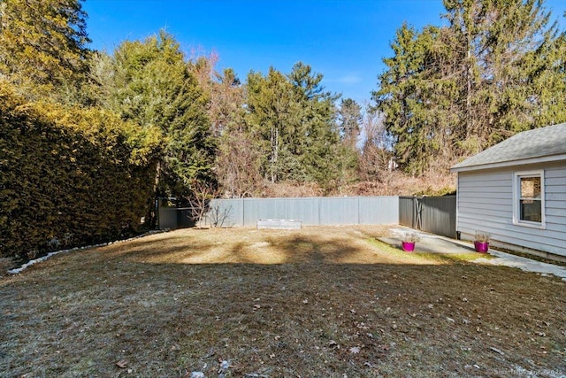 view of yard with fence and a patio