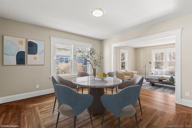 dining area with plenty of natural light, baseboards, and wood finished floors