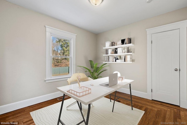 home office with baseboards and wood finished floors