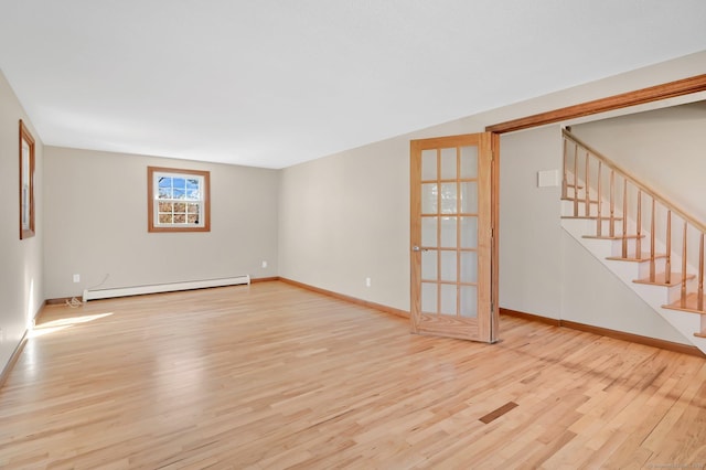 unfurnished living room with stairs, baseboards, baseboard heating, and wood finished floors