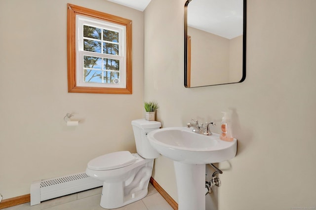 bathroom with a baseboard heating unit, tile patterned flooring, toilet, and baseboards