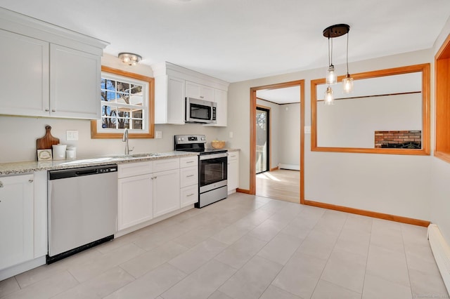 kitchen with baseboard heating, white cabinetry, stainless steel appliances, and a sink